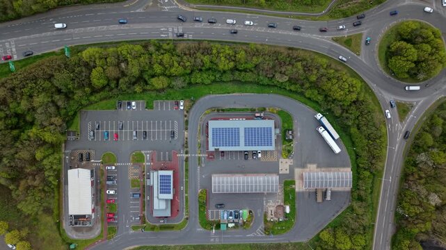 Drone shot of a commercial petrol station forecourt and road infrastructure during high fuel demand in the UK