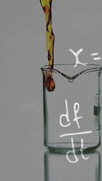 Beaker receiving amber droplet, overflowing with swirl, chalk df or dt overlay illustrating chemistr