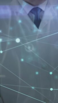 Vertical video: Lab scientist writing on pad by tubes, analyzing samples with overlay crossing face