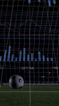 Vertical video: Goalkeeper diving to stop ball after drop, sports HUD overlay tracking save metrics