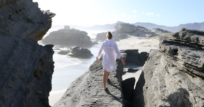 teenage girl overlooking beautiful rocky coastline, Sopies Klip, Hermanus, South Africa