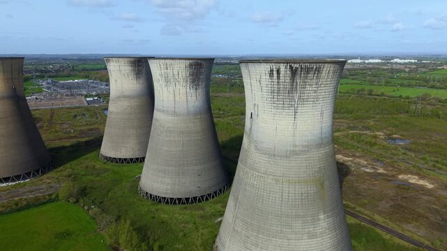 Aerial drone view of the decommissioned Willington B Power Station cooling towers, derelict industrial landmarks in Derbyshire, United Kingdom.