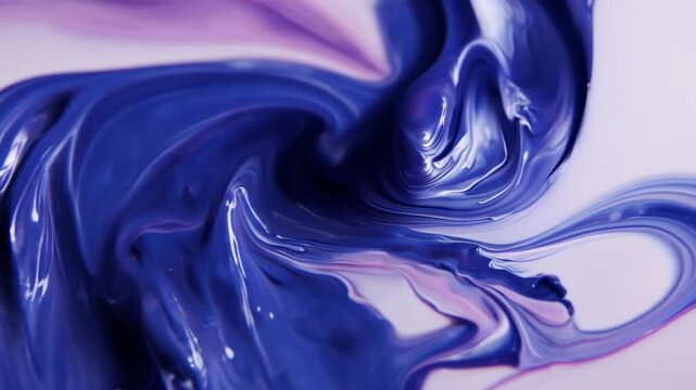 Abstract swirls of blue and purple paint blending together smoothly