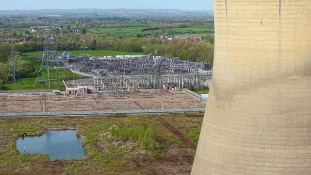 Industrial ruins of Willington B cooling towers with high voltage electrical substation in background