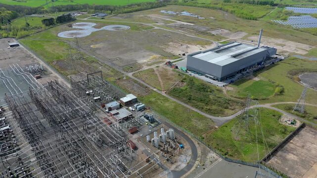 Top down perspective of the National Grid substation at Drakelow, featuring high voltage transformers and pylons in Derbyshire, England.