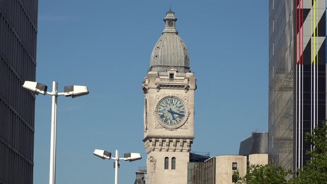 Belle Epoque architecture of Gare de Lyon clock tower in  Paris, France. Sunny afternoon, clear blue sky.