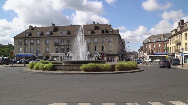 Traffic circle with a central fountain in the city center of Creil, France