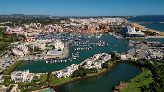 Aerial View on Beach and Marina of Vilamoura Algarve Portugal, flying sideways from left to right