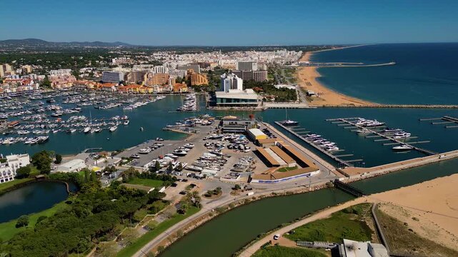 Aerial View on Beach and Marina of Vilamoura Algarve Portugal, flying sideways from right to left