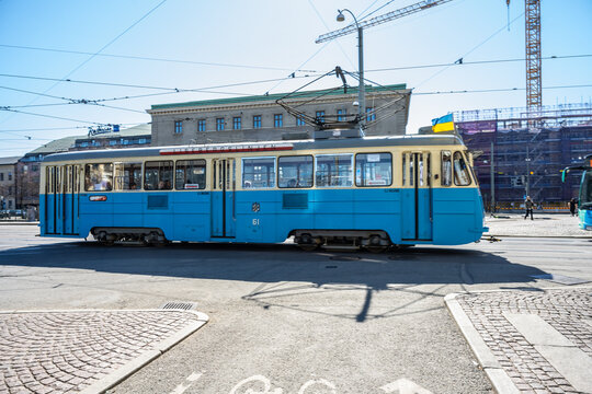 Gothenburg, Sweden - April 22 2023: Historic blue tram on city street in sunlight.