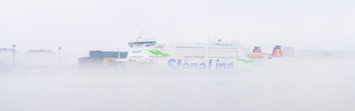 Gothenburg, Sweden - February 28 2026: Large Stena Line ferry emerging through dense harbor fog.