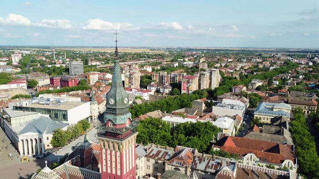 Cinematic drone ascending shot revealing a wide panorama of Subotica city under a clear blue sky, northern Serbia.