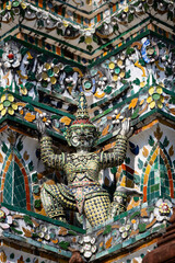Naklejka premium Colorful mosaic guardian statues on ornate temple wall