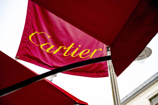 Brand logo of flagship store of luxury brand Cartier, a boutique selling high end jewellery and watches in the fashionable West End district of Mayfair, London, UK