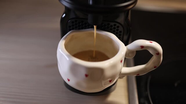 Coffee machine preparing drink pouring into cup demonstration of appliance use kitchen technology beverage making process modern household concept