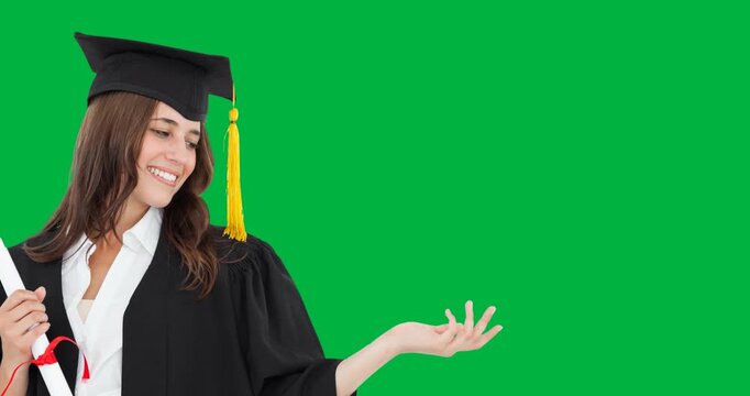 Caucasian college girl wearing graduation gown and hat holding an invisible object