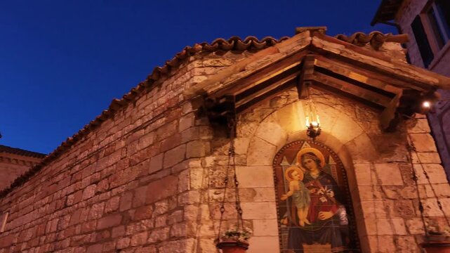 Madonna and Child Fresco on Aged Stone Wall in Assisi, Italy