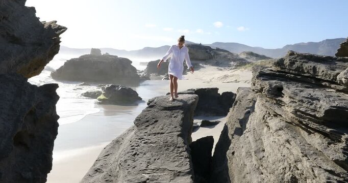 teenage girl overlooking beautiful rocky coastline, Sopies Klip, Hermanus, South Africa