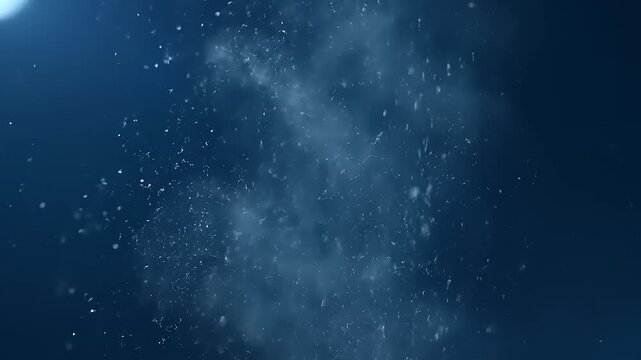Water droplets falling in dark ocean.