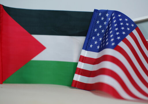 The US and Palestinian flags. The concept of US-Palestinian diplomacy. The conflict between America and Palestine.