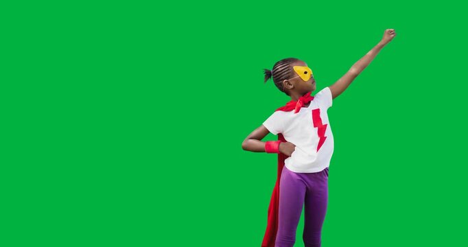 African american girl wearing a superhero costume flying against black background