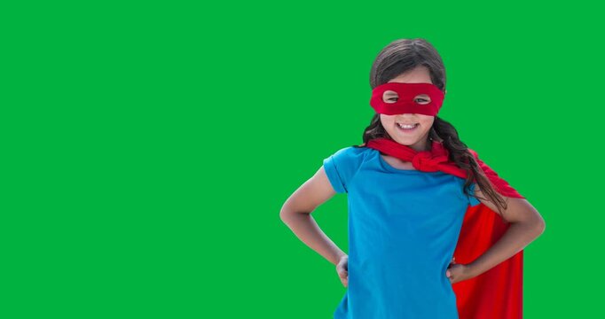 Caucasian girl wearing a superhero costume with hands on hips against black background