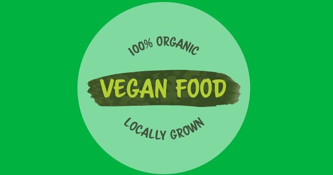 Digital animation of 100 percent vegan food text over a grey round banner on black background