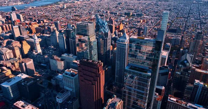 Rising over contemporary downtown of Philadelphia, Pennsylvania, USA. Bright sun lights the panorama of the city.