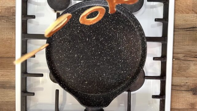 Pancake Letters Forming Word Cook in Reverse Motion on Frying Pan, Creative Food Concept