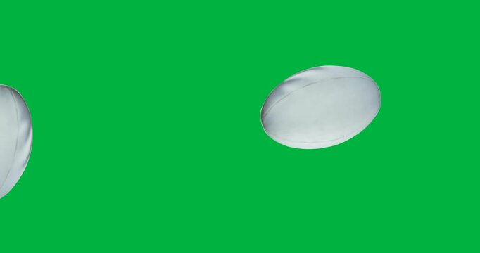 Digital animation of multiple rugby balls falling against black background