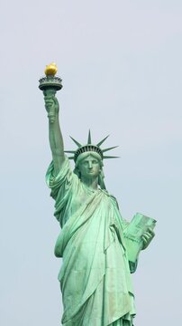 Statue of Liberty viewed from ferry boat crossing New York Harbor on sunny day