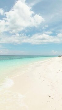 Boat over shoreline. White sandbar in Mantigue Island. Camiguin, Philippines. Vertical view.