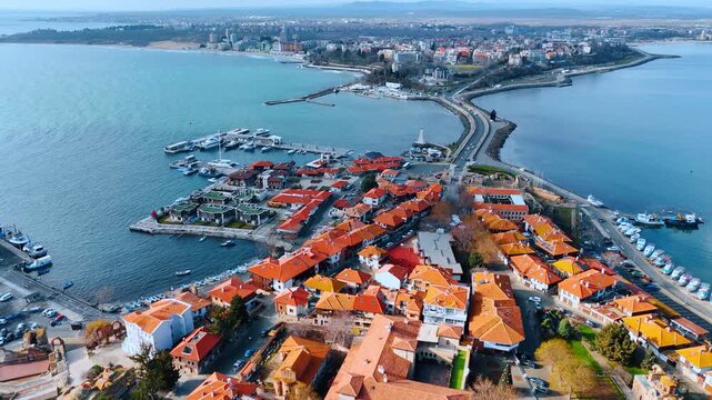Panoramic aerial view of old coastal town peninsula. Red tiled roofs of traditional houses on a seaside peninsula.
