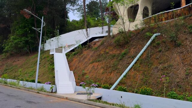 Park hillside scenic spot white modern geometric staircase forest background morning sunlight peaceful atmosphere 4K ProRes video.