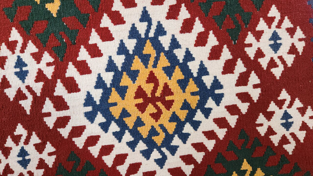 A Turkish Kilim rug traditionally handwoven using wool or cotton yarns. A flat-woven rug made with a knotless weaving technique.