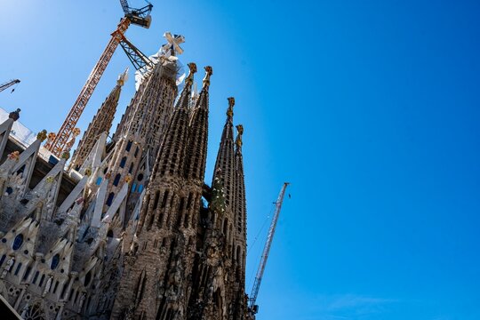 The Basilica Sagrada Fam&iacute;lia as viewed from the outside.  The Sagrada Fam&iacute;lia is a basilica that has been in construction since 1882.