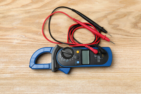 Set of electrician items on a wooden background
