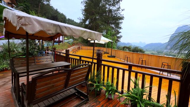 Scenic mountain view terrace wooden deck bar stools karst peaks cloudy peaceful atmosphere video.