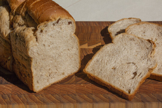 It is a slice of bread placed on a wooden cutting board.
