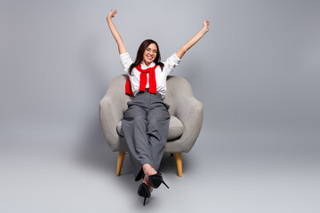 Relaxed business woman stretching back in armchair after successful meeting, smiling and confident...