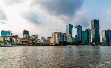 Obraz premium A view from the Saigon River towards the commercial centre of Ho Chi Minh City. Vietnam on bright spring day