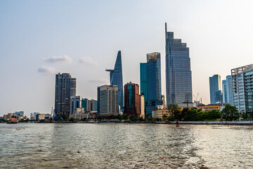 Fototapeta premium A view from the Saigon River towards the modern skyline of Ho Chi Minh City. Vietnam on bright spring day