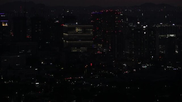 Cinematic night street view of Seoul's modern architecture and lights