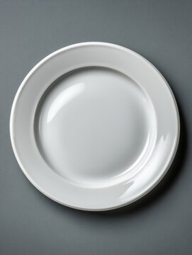 Minimalist empty white ceramic plate in top-down view with soft neutral lighting on dark background, clean simple composition, modern elegant tabletop design