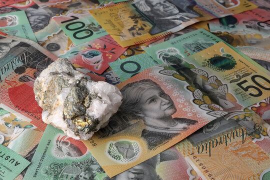 Copper mine, mining Australia. Chalcopyrite ore isolated on Australian Dollar currency, money, notes. Investment, financial stock market, Australian Securities Exchange