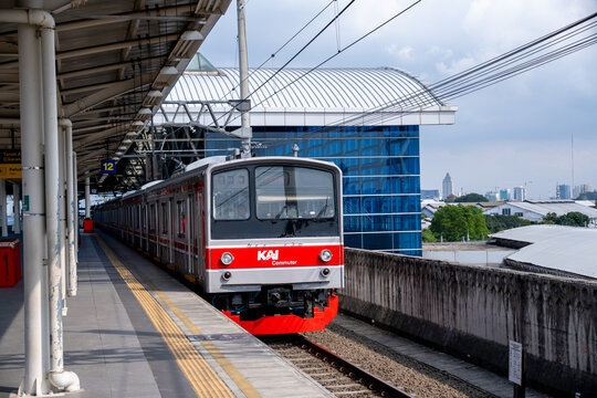 Jakarta, Indonesia - March 24, 2026: A KAI Commuter train bound for Bogor at the elevated platform of Manggarai Station, with a modern white metal roof and spacious station infrastructure.