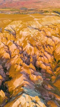 Vertical video. Goreme, Nevsehir, Turkey. Panoramic aerial view of Devrent Valley and surrounding Cappadocia landscape with unique rock formations and valleys.. Aerial View. Rich colors