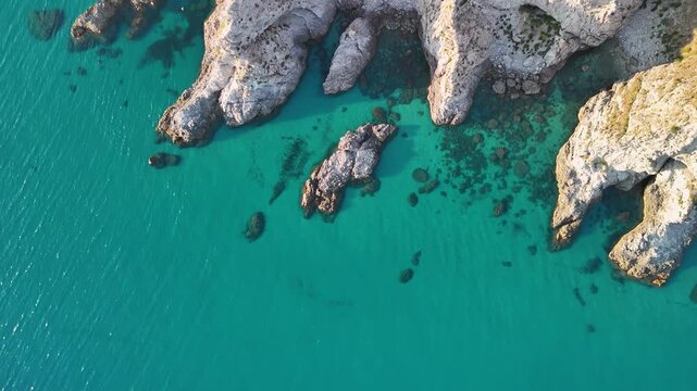 Breathtaking summer aerial panorama of Calabria's Capo Vaticano coastline, showcasing dramatic white cliffs plunging into the crystal-clear turquoise waters