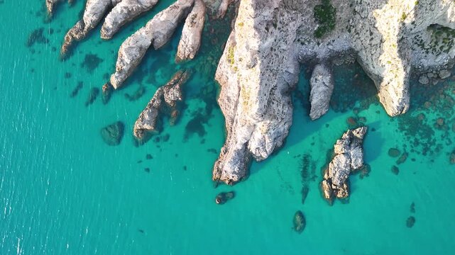 Breathtaking summer aerial panorama of Calabria's Capo Vaticano coastline, showcasing dramatic white cliffs plunging into the crystal-clear turquoise waters
