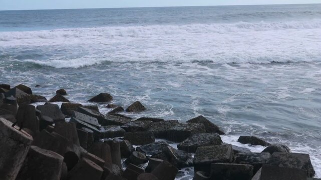 Concrete sea breakwaters that form a coastal breakwater protection at Glagah Beach, Yogyakarta.